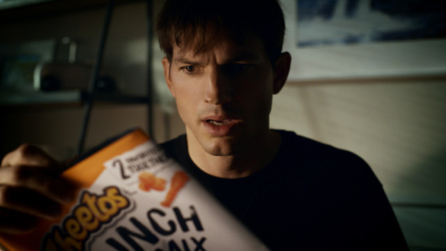 ashton-kutcher-is-primed-to-crack-a-cheetle-coated-case-in-cheetos’-new-super-bowl-teaser